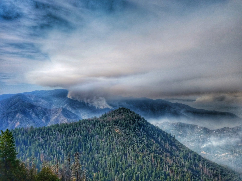 Smoke rises near Pinoche Peak on the east flank of the Ferguson Fire looking towards Chowchilla Mountain in this Yosemite Fire and Aviation photo from California, U.S. released on social media on July 23, 2018. Picture taken on July 23, 2018.   Courtesy Yosemite Fire and Aviation/USDA/US Forest Service/Handout via REUTERS  