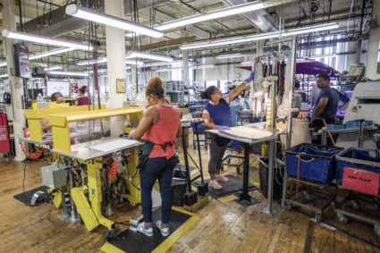 Workers assemble sneakers at the New Balance Inc. manufacturing facility in Lawrence, Massachusetts, U.S., on Tuesday, July 31, 2018. The U.S. Census Bureau is scheduled to release factory orders figures on August 2. Photographer: Scott Eisen/Bloomberg via Getty Images