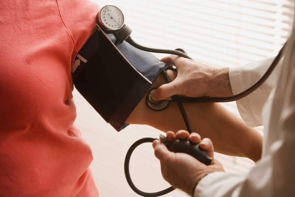 Woman having her blood pressure checked. Photo via Getty Images