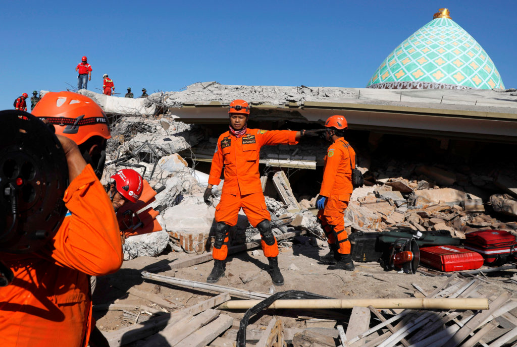 Rescue team members work at a site near a mosque after an earthquake in Pemenang, Lombok Island, Indonesia, on Aug. 8. Pho...