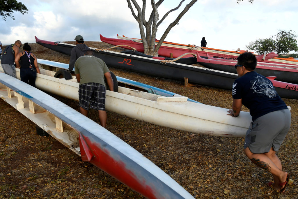Members of the Alapahoe outrigger canoe club move their canoes off the beach to higher ground as Hurricane Lane approaches Honolulu. Photo by Hugh Gentry/Reuters