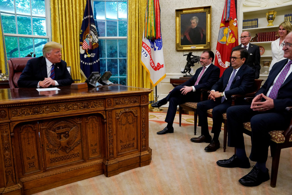 President Donald Trump speaks with Mexican representatives in trade negotiations at the White House on Aug. 27. Photo by K...