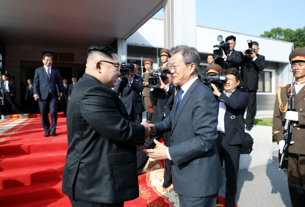 South Korean President Moon Jae-in shakes hands with North Korean leader Kim Jong Un as he leaves after their summit at th...