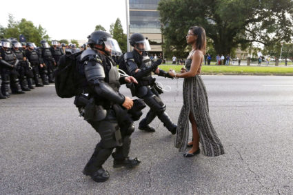 Lone activist Ieshia Evans stands her ground while offering her hands for arrest as she is charged by riot police during a protest against police brutality outside the Baton Rouge Police Department in Louisiana, USA, 9 July 2016. Photo by REUTERS/Jonathan Bachman