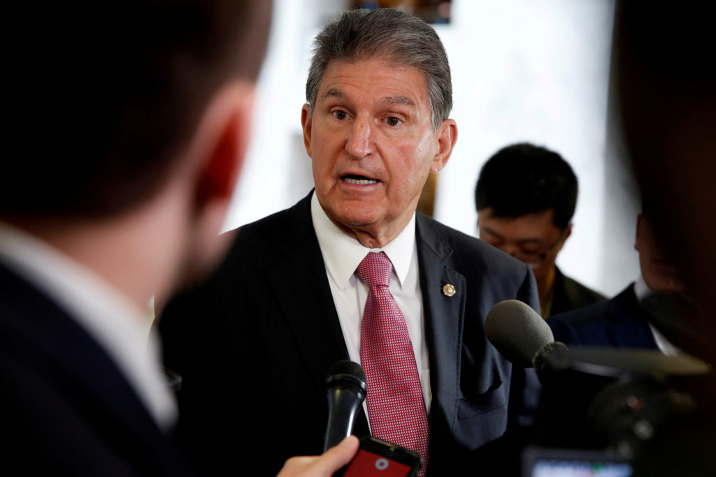 FILE PHOTO: Senator Joe Manchin (D-WV) speaks to the media as he arrives for a Senate Intelligence Committee hearing evalu...