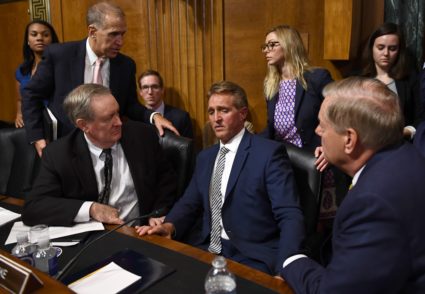 Senate Judiciary Committee member Senator Jeff Flake (R-Ariz.) speaks with committee colleagues during a hearing on Capitol Hill in Washington, DC on September 28, 2018, on the nomination of Brett M. Kavanaugh to be an associate justice of the Supreme Court of the United States. Photo by Brendan Smialowski/AFP/Getty Images