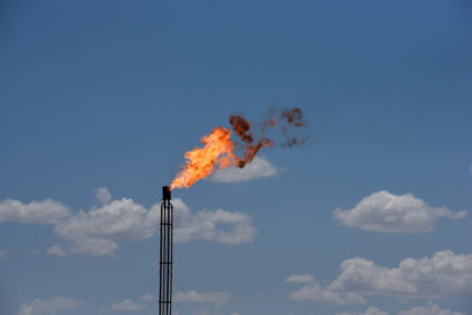 A flare burns off excess gas from a gas plant in the Permian Basin oil production area near Wink, Texas U.S. August 22, 2018. Photo by REUTERS/Nick Oxford