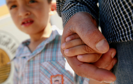 Salvadoran migrant Epigmenio Centeno holds the hand of his three-year old son Steven Atonay outside the shelter House of the Migrant, after he has decided to stay with his children in Mexico due to U.S. President Donald Trump's child separation policy, in Ciudad Juarez, Mexico June 19, 2018. Photo by Jose Luis Gonzalez/Reuters