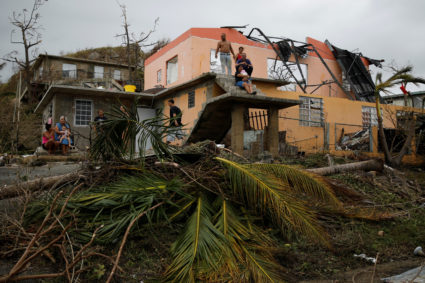 People rest outside a damaged house after the area was hit by Hurricane Maria in Yabucoa, Puerto Rico on September 22, 2017. Photo by Carlos Garcia Rawlins/Reuters