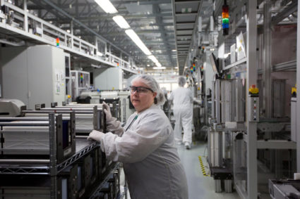 Production operator Wendy Love, pushes a cart laden with cells at the SolarWorld solar panel factory in Hillsboro, Oregon, U.S., January 15, 2018. REUTERS/Natalie Behring