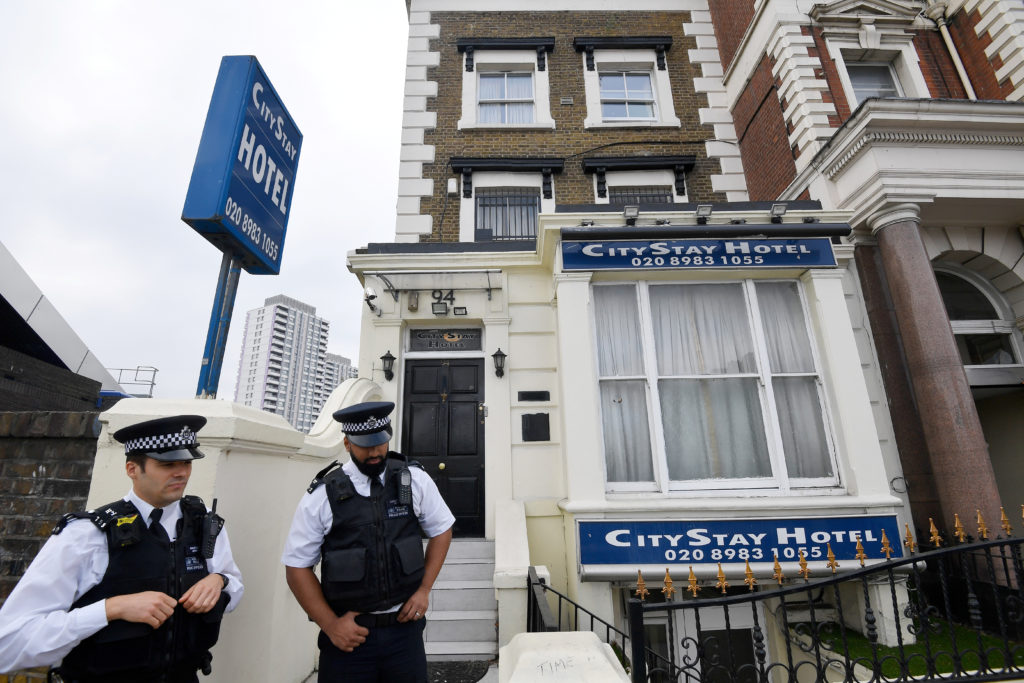 Police officers on Sept. 5 stand outside the City Stay Hotel used by suspects Alexander Petrov and Ruslan Boshirov. Photo ...
