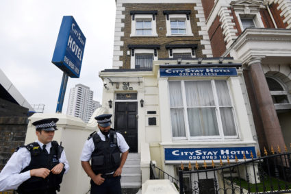 Police officers on Sept. 5 stand outside the City Stay Hotel used by suspects Alexander Petrov and Ruslan Boshirov. Photo by Toby Melville/Reuters