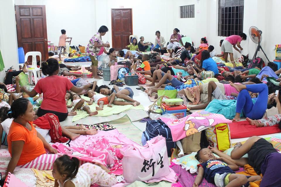 People are seen inside an evacuation centre in preparation for Typhoon Mangkhut in Cagayan, Philippines, in this September...