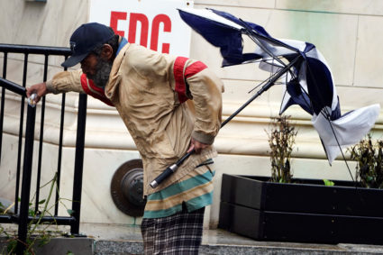 A man holds on to a rail after Hurricane Florence struck Wilmington, North Carolina. Photo by Carlo Allegri/Reuters