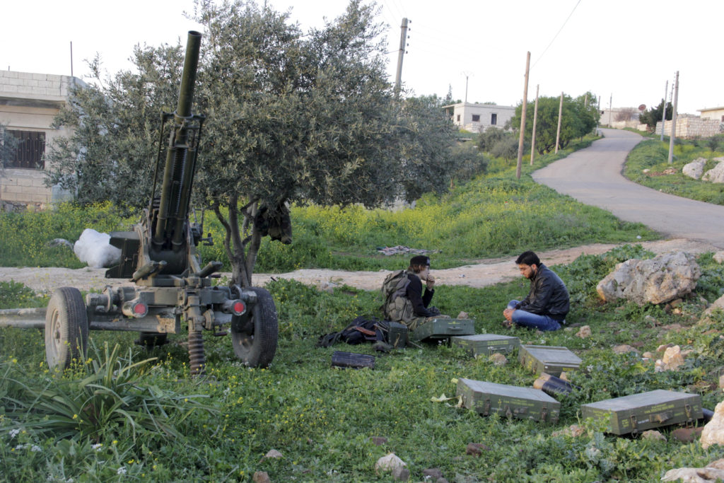 Ansar Al-Sham Brigade fighters rest with their weapons near Jisr al-Shoghour, Idlib province, Syria on March 25, 2015. Fil...