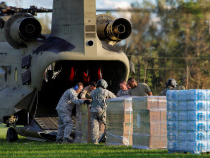 U.S. Army personnel unload food and water from a CH-47 Chinook helicopter for a community isolated by the effects of Hurricane Florence, now downgraded to a tropical depression, in Atkinson, North Carolina, on Sept. 18. Photo by Jonathan Drake/Reuters