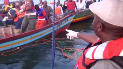 Rescue workers are seen at the scene where a ferry overturned in Lake Victoria, Tanzania, in this still image taken from video. Image via Reuters TV