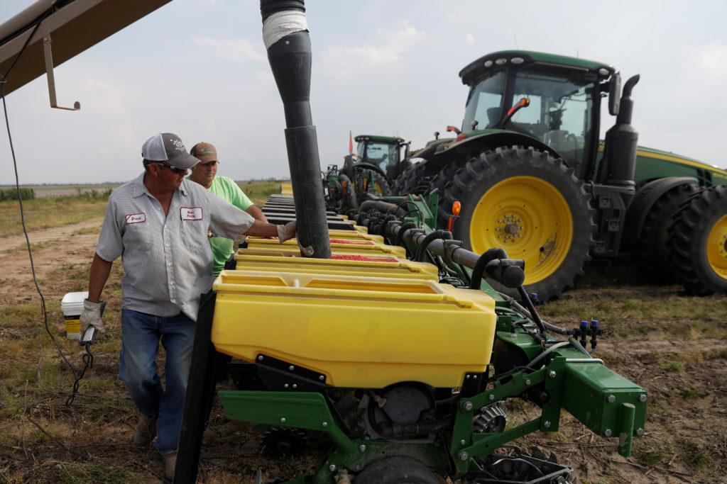 Bruce Edler, 56, a farmer for 40 years, fills seed planters with soybean seed in Gideon, Missouri, U.S., May 16, 2018. Pic...
