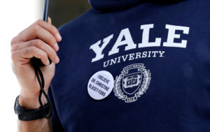A man wears a Yale University sweatshirt and a pin supporting Christine Blasey Ford during a protest against U.S. Supreme Court nominee Brett Kavanaugh in front of the Supreme Court in Washington, U.S., September 24, 2018. Photo by REUTERS/Joshua Roberts