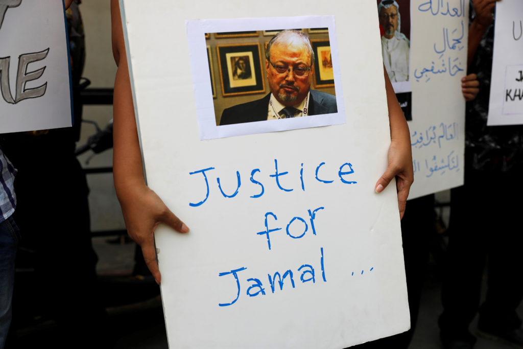 An Indonesian journalist holds a placard during a protest over the killing of Saudi journalist Jamal Khashoggi in front of...