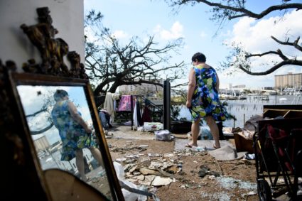 Teresa Sheffield walks out of the remains of her second floor apartment in the aftermath of Hurricane Michael October 11, 2018 in Panama City, Florida. - Residents of the Florida Panhandle woke to scenes of devastation Thursday after Michael tore a path through the coastal region as a powerful hurricane that killed at least two people. (Photo by Brendan Smialowski / AFP) (Photo credit should read BRENDAN SMIALOWSKI/AFP/Getty Images)