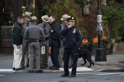 Law enforcement officials gather near the scene of where another package bomb was found early Thursday morning at Robert De Niro's Tribeca Grill restaurant in New York City. Initial news reports suggest that the package contained similar markings and contents as recent pipe bomb packages that have been mailed to high-profile Democrats. Photo by Drew Angerer/Getty Images