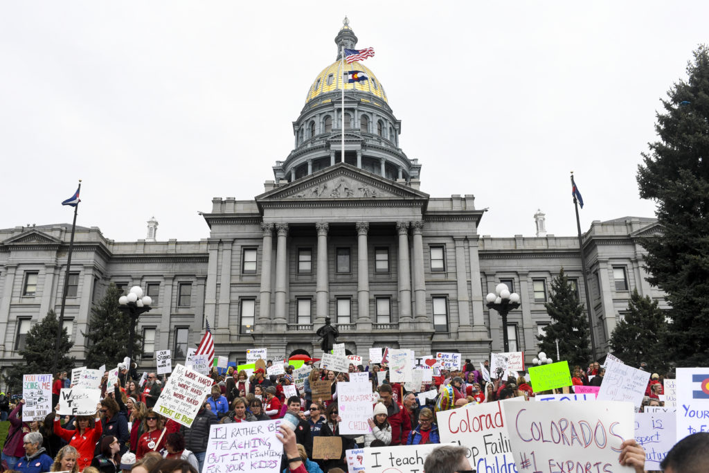DENVER, CO - APRIL 26: Educators gather en masse wearing red and holding signs during a teachers rally for more educationa...
