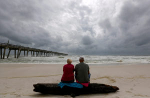 A local couple, who asked not to be named, watch waves come ashore in advance of Hurricane Michael in Pensacola, Florida. Photo by Jonathan Bachman/Reuters