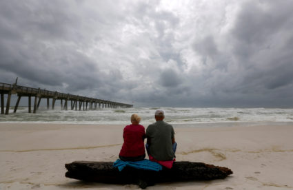 A local couple, who asked not to be named, watch waves come ashore in advance of Hurricane Michael in Pensacola, Florida. Photo by Jonathan Bachman/Reuters
