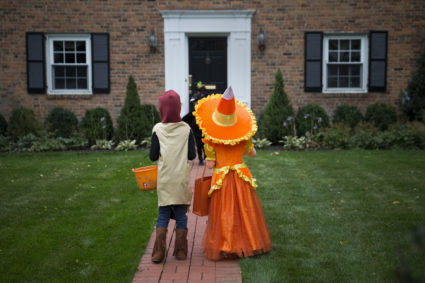 Kids dressed in costumes wait for candy while trick or treating during Halloween in Port Washington, New York, October 31, 2014. Photo by Shannon Stapleton/Reuters