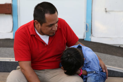 Walter Armando Jimenez Melendez, an asylum seeker from El Salvador, arrives with his four year-old son Jeremy at La Posada Providencia shelter in San Benito, Texas, shortly after he said they were reunited following separation since late May while in detention. Photo by Loren Elliott/Reuters