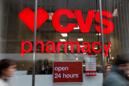 People walk by a CVS Pharmacy store in the Manhattan borough of New York City, New York, U.S., November 30, 2017. REUTERS/Shannon Stapleton