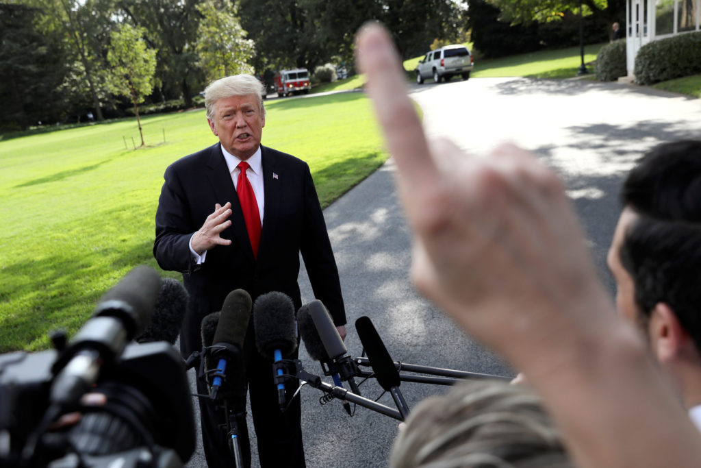 President Donald Trump speaks to reporters while departing the White House for travel to a campaign rally in Iowa in Washi...