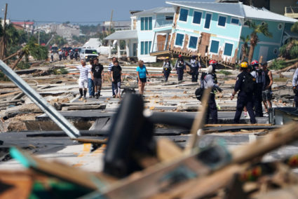 First responders and residents walk along a main street following Hurricane Michael in Mexico Beach, Florida. Photo by Carlo Allegri/Reuters
