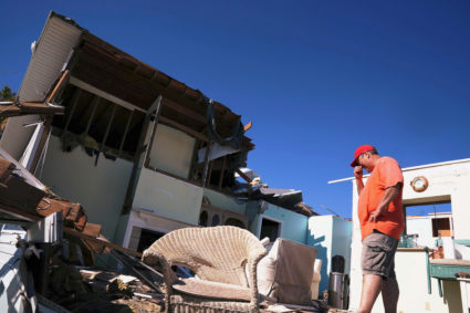 A man stands in the living room of his house with no roof following Hurricane Michael in Mexico Beach, Florida. Photo by Carlo Allegri/Reuters
