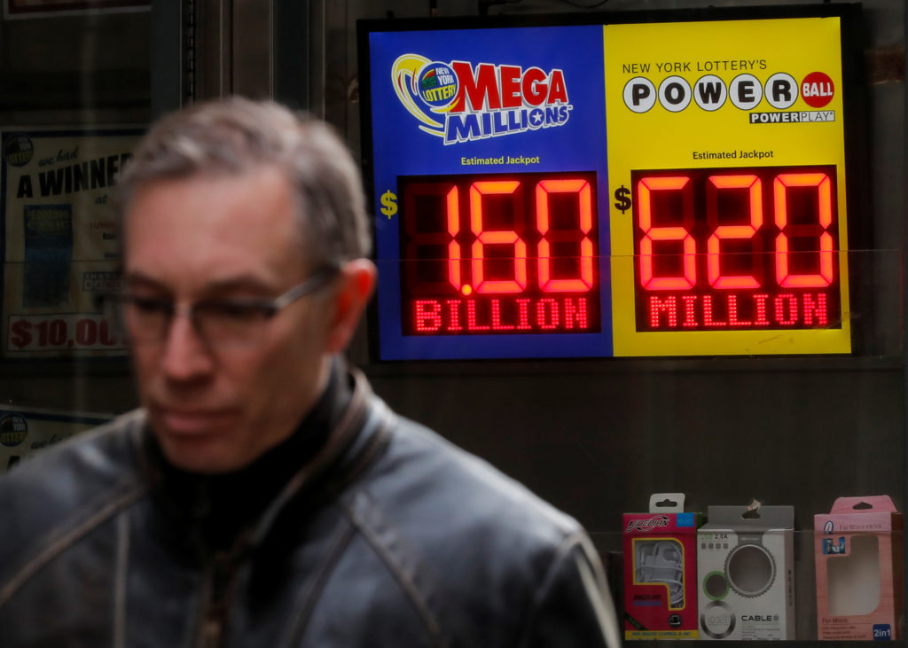 Signs display the jackpots for Tuesday's Mega Millions and Wednesday's Powerball lottery drawings in New York City. Photo ...