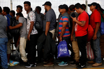 Central American migrants wait on the bridge that connects Mexico and Guatemala to cross into Mexico to continue their trip north, in Ciudad Hidalgo, Mexico on Oct. 23. Photo by Edgard Garrido/Reuters