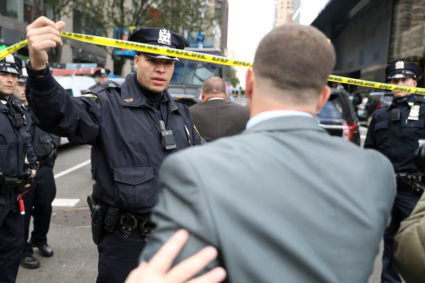 Police allow someone through the perimeter outside the Time Warner Center in the Manhattan borough of New York City after a suspicious package was found inside the CNN Headquarters in New York. Photo by Kevin Coombs/Reuters