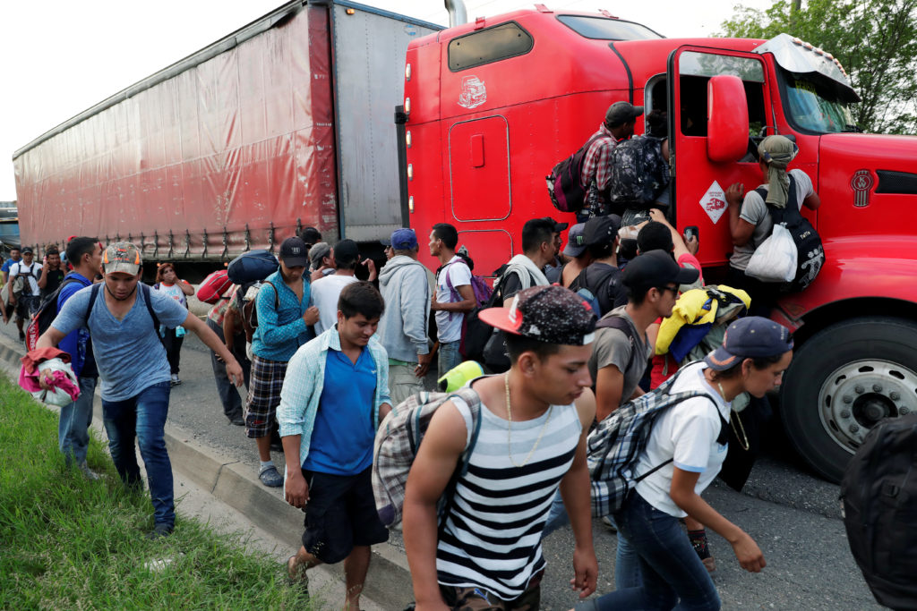 Central American migrants, part of a second wave heading to Mexico, try to hitchhike a on a trailer truck in Zacapa, Guate...