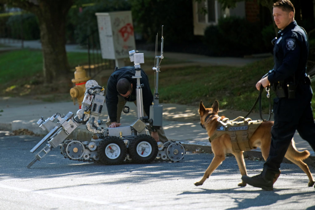 Law enforcement personnel and bomb disposal robot outside a post office which had been evacuated in Wilmington, Delaware, ...
