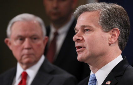 U.S. Attorney General Jeff Sessions listens as FBI Director Christopher Wray addresses a news conference to discuss an arrest related to the investigation of at least a dozen parcel bombs sent to Democratic politicians and high-profile critics of President Trump, at the Justice Department in Washington, U.S., October 26, 2018. REUTERS/Jonathan Ernst - RC1DEA1DA400
