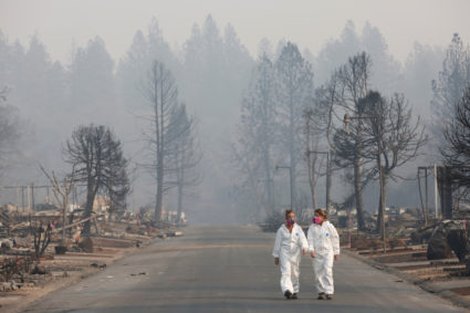 Forensic anthropologists Kyra Stull (L) and Tatiana Vlemincq walk through a trailer park destroyed by the Camp Fire in Paradise, California, U.S., November 17, 2018. REUTERS/Terray Sylvester