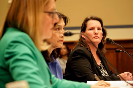 Former U.S. Forest Service employee Shannon Reed listens as the agency's chief Vicki Christiansen testifies before a House committee hearing Thursday. Photo by William Brangham/PBS NewsHour