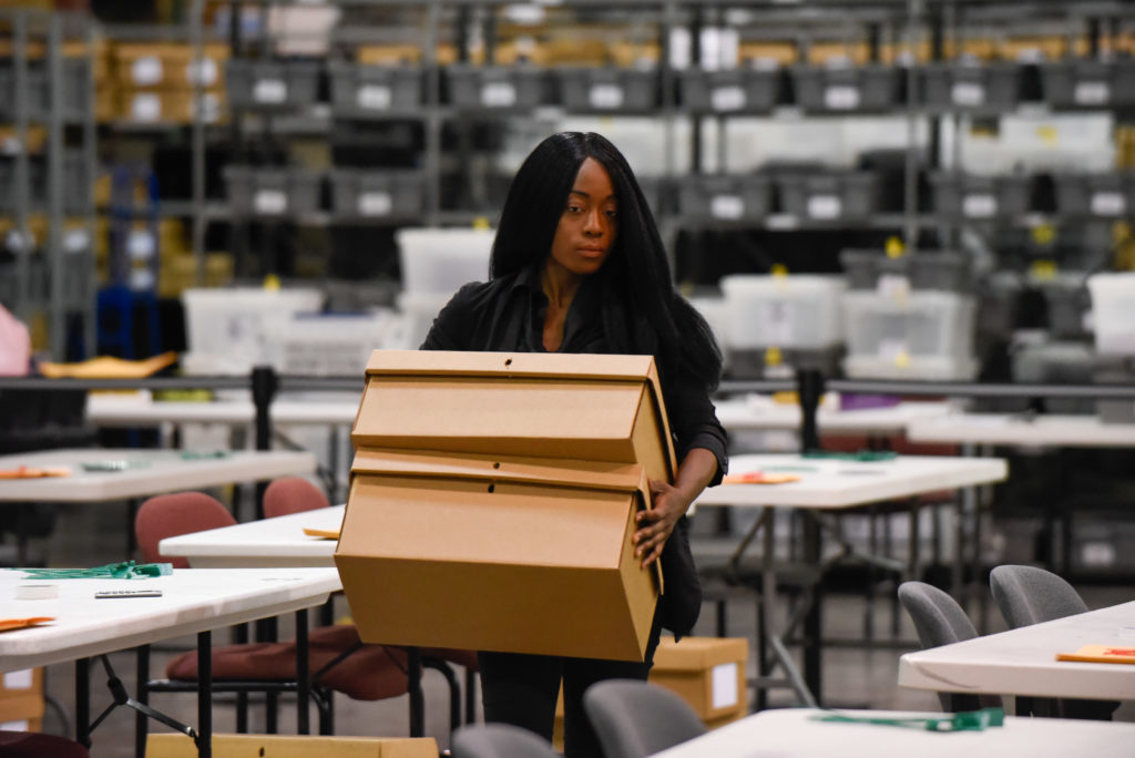 A woman sets up tables for hand counting ballots on Nov. 15, 2018, as Palm Beach County did not meet the midterm recount d...