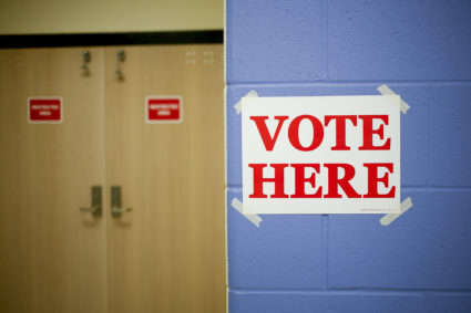 A "Vote Here" sign is displayed at a polling station in the Kentucky National Guard Readiness Center in Burlington, Kentucky, U.S., on Tuesday Nov. 4, 2014. After blowing opportunities to win Senate control in 2010 and 2012, several political modeling outlets found the Republican Party poised to gain the six seats needed to win the chamber, even if that outcome isn't immediately known. Photographer: Luke Sharrett/Bloomberg via Getty Images