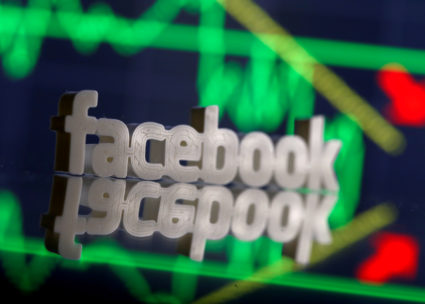 A 3D-printed Facebook logo is seen in front of displayed stock graph in this illustration photo, March 20, 2018. REUTERS/Dado Ruvic/File Photo - RC190168FA10