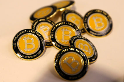 Bitcoin.com buttons are seen displayed on the floor of the Consensus 2018 blockchain technology conference in New York City. Bitcoin has lost about 40 percent of its value in the last month. iPhoto by Mike Segar/Reuters
