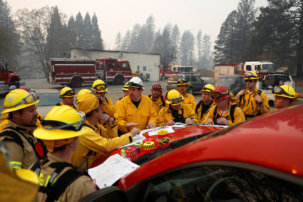 Firefighters gather for a morning briefing during the Camp Fire in Paradise, California, U.S. November 10, 2018. Photo by Stephen Lam/Reuters