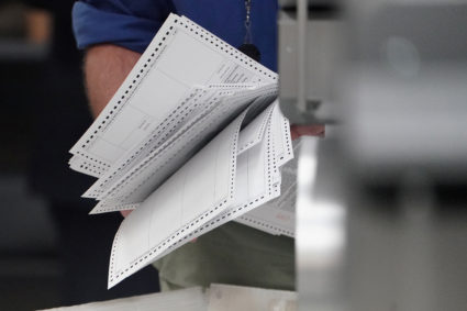 A worker holds ballots before a ballot recount in Lauderhill, Florida. Photo by Carlo Allegri/Reuters