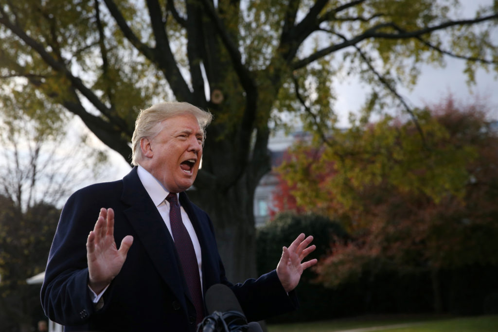 President Donald Trump speaks to the news media while walking to board Marine One to depart for travel to Mar-a-Lago from ...